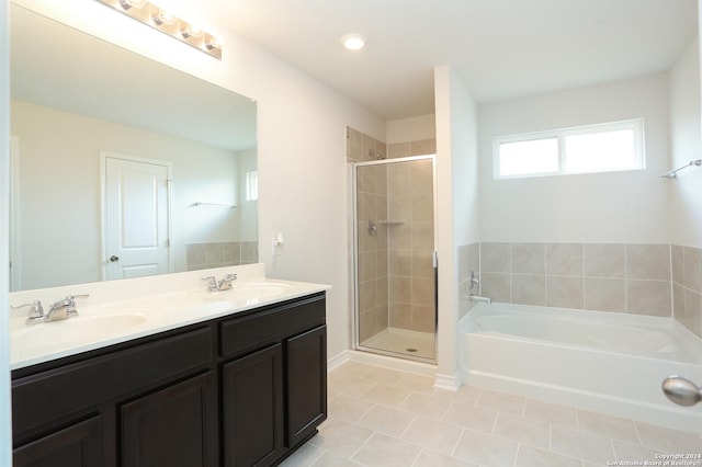 bathroom with tile patterned floors, vanity, and plus walk in shower