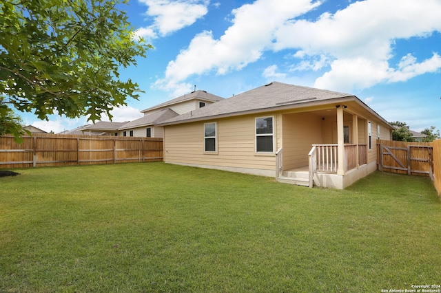 rear view of house with a lawn