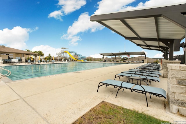 view of pool featuring a patio and a water slide