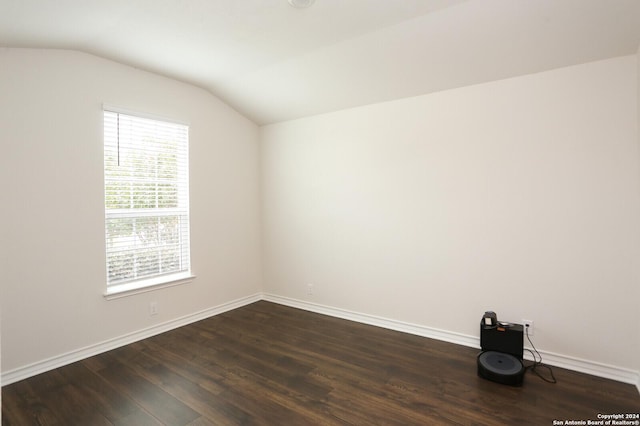 empty room featuring dark hardwood / wood-style flooring and lofted ceiling