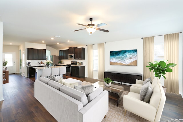 living room with ceiling fan, dark hardwood / wood-style flooring, and lofted ceiling