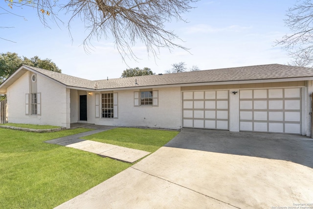 single story home with a front yard and a garage