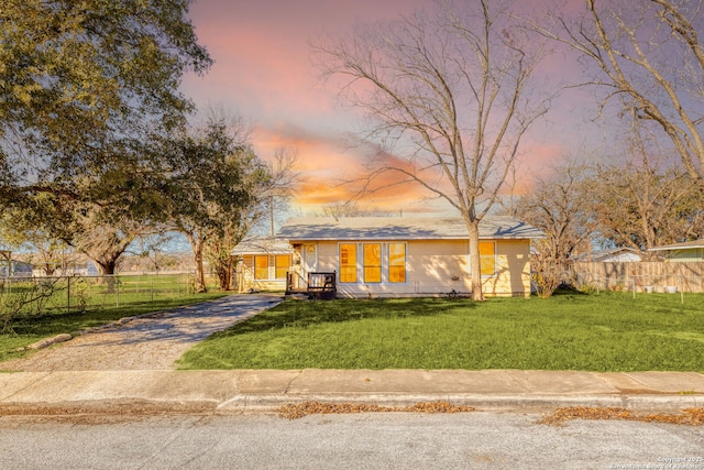 ranch-style home featuring a yard