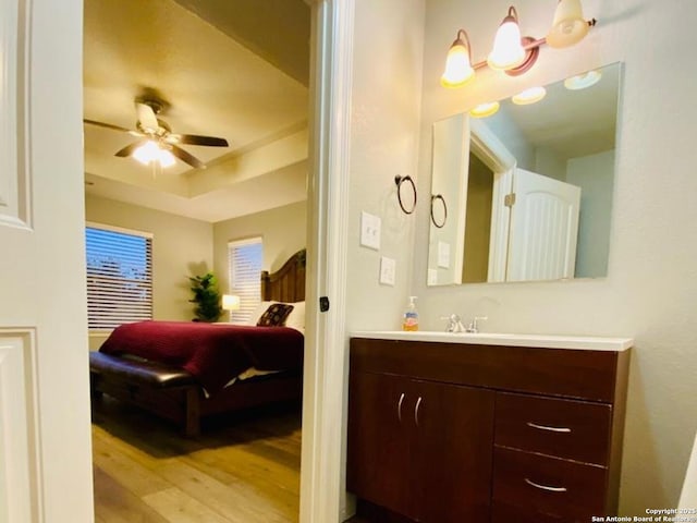 bathroom featuring ceiling fan, vanity, and hardwood / wood-style flooring