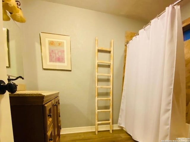 bathroom with hardwood / wood-style flooring and vanity