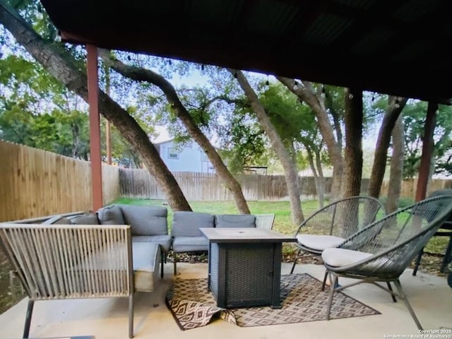 view of patio featuring an outdoor living space with a fire pit