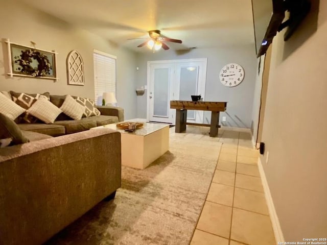 tiled living room with ceiling fan