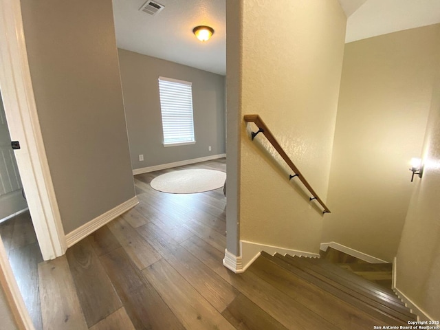 stairway featuring hardwood / wood-style flooring