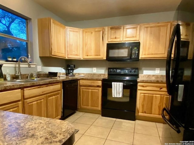 kitchen with light brown cabinetry, light tile patterned floors, black appliances, and sink