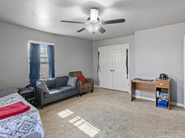 bedroom featuring ceiling fan, a closet, a textured ceiling, and carpet