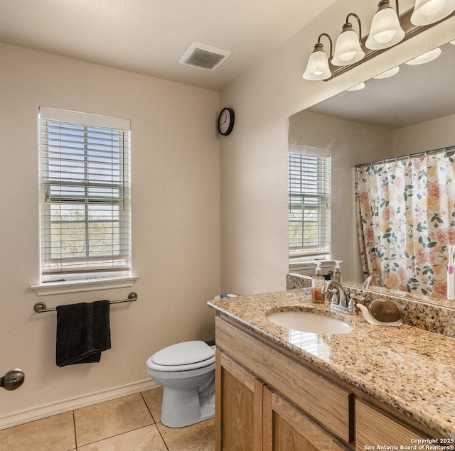 bathroom featuring tile patterned floors, vanity, and toilet