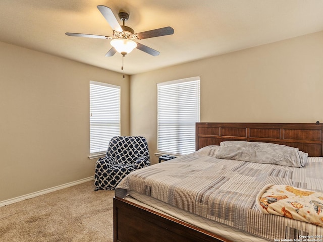 bedroom featuring light colored carpet and ceiling fan