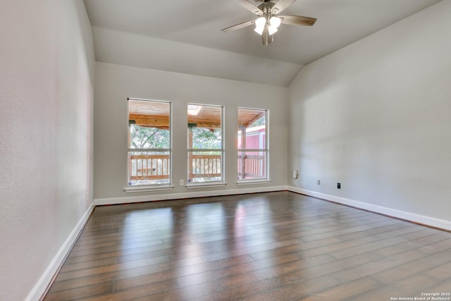 spare room featuring lofted ceiling, dark hardwood / wood-style floors, and ceiling fan