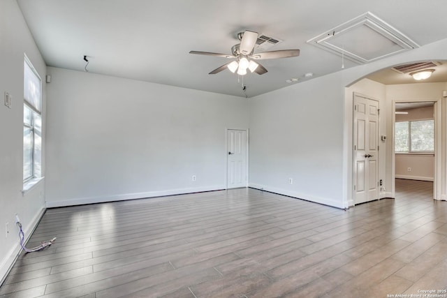 unfurnished room with hardwood / wood-style flooring and ceiling fan