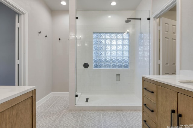 bathroom featuring a shower with door, vanity, and tile patterned floors