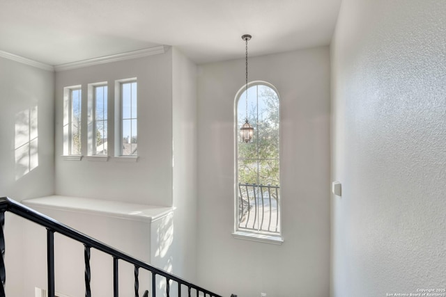 interior space with crown molding and a chandelier