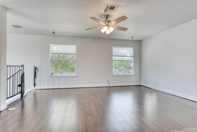 empty room with dark wood-type flooring and ceiling fan