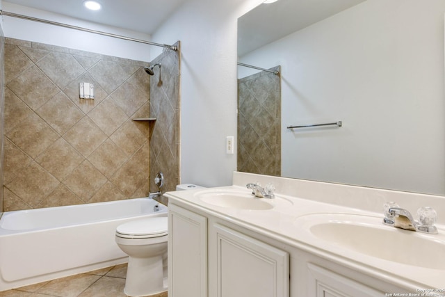 full bathroom with tiled shower / bath, vanity, toilet, and tile patterned flooring