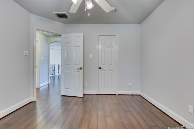 unfurnished bedroom featuring ceiling fan and dark hardwood / wood-style floors