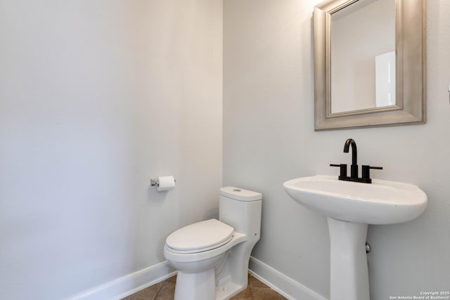 bathroom with tile patterned flooring and toilet