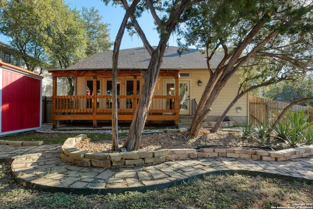 back of house featuring a deck