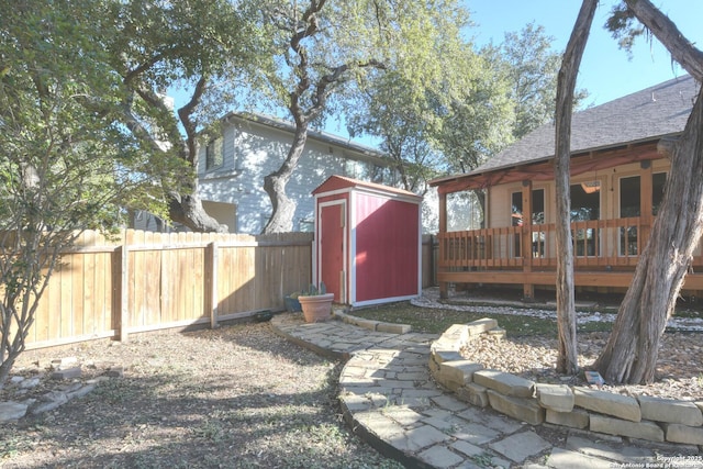 view of yard with a storage shed and a wooden deck