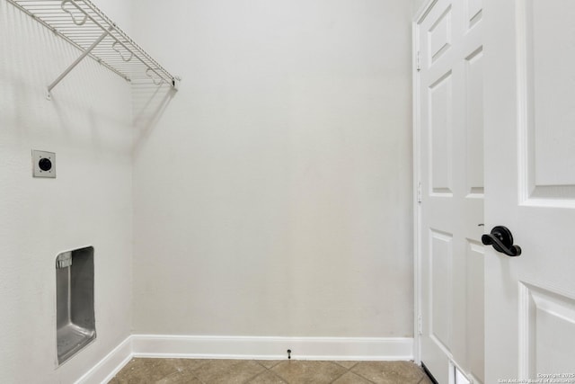 washroom with hookup for an electric dryer and tile patterned floors