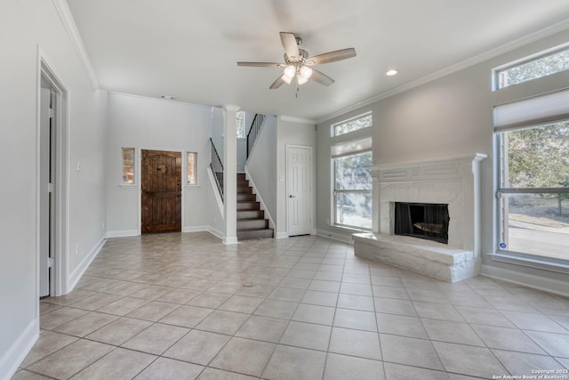 unfurnished living room with a wealth of natural light, ornamental molding, and light tile patterned flooring