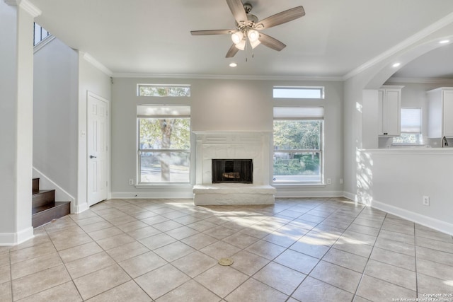 unfurnished living room with crown molding and light tile patterned flooring