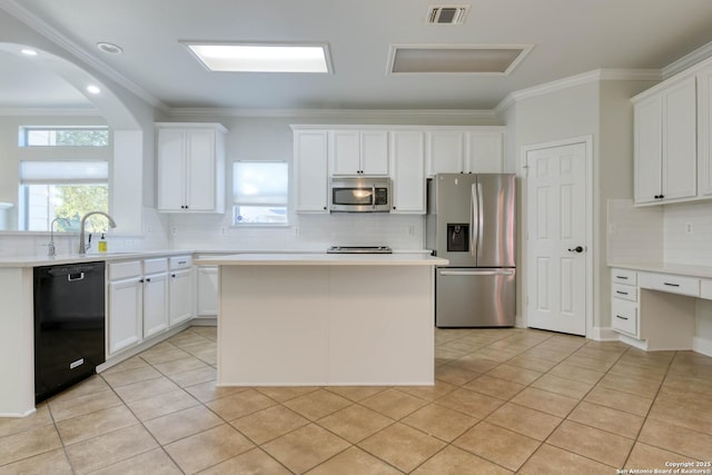 kitchen with stainless steel appliances, white cabinetry, a center island, and sink