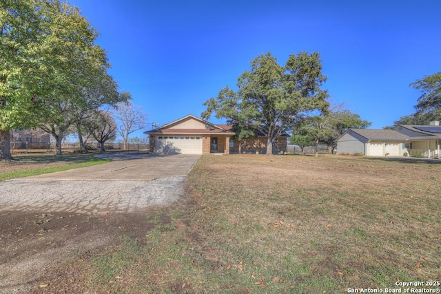 ranch-style home featuring a garage and a front lawn