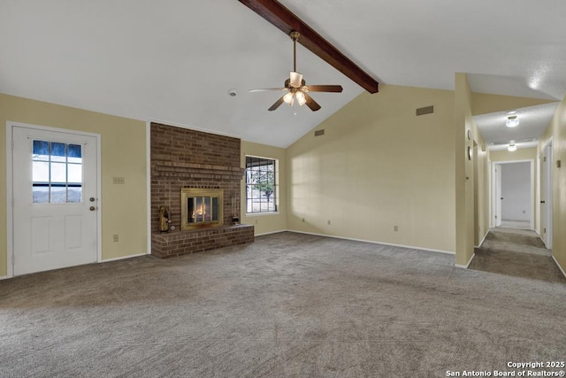 unfurnished living room featuring plenty of natural light, a brick fireplace, ceiling fan, and vaulted ceiling with beams