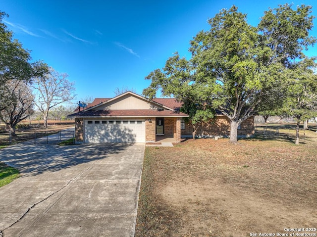 ranch-style house featuring a garage and a front lawn