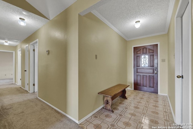 carpeted foyer featuring a textured ceiling and crown molding