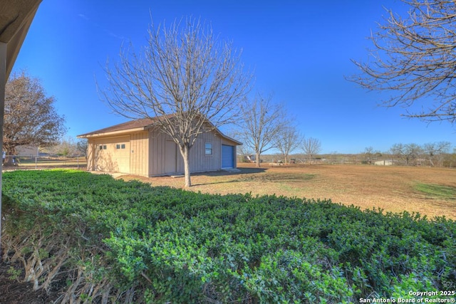 view of yard with a rural view and an outdoor structure