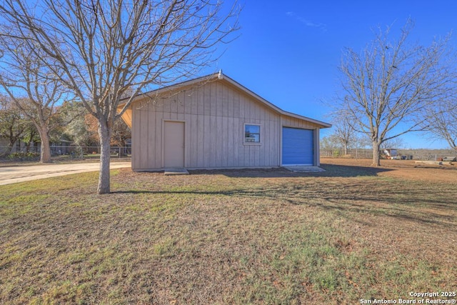 view of outbuilding featuring a yard and a garage