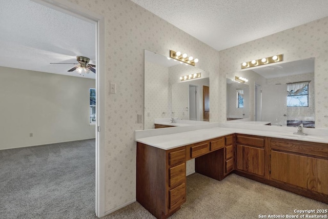 bathroom with vanity, a textured ceiling, and ceiling fan