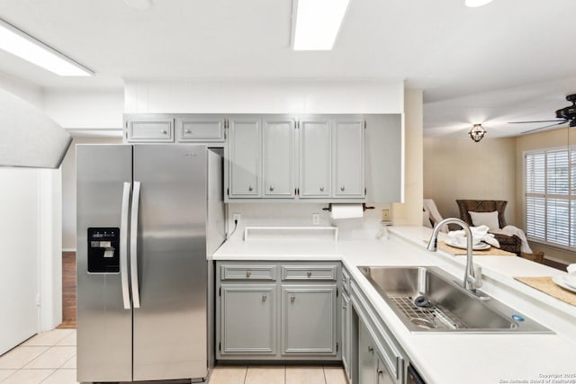 kitchen featuring gray cabinetry, light tile patterned floors, stainless steel refrigerator with ice dispenser, and sink