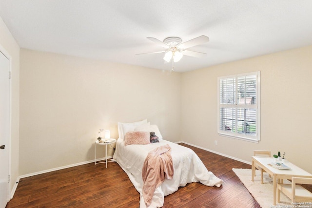 bedroom with ceiling fan and dark hardwood / wood-style floors