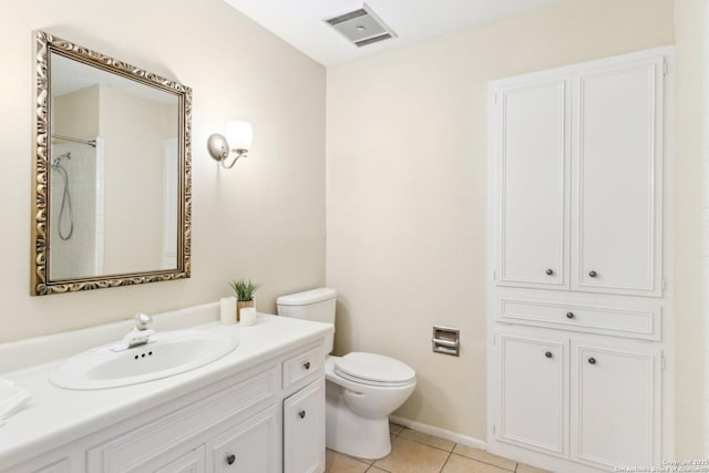 bathroom featuring toilet, a shower, tile patterned floors, and vanity