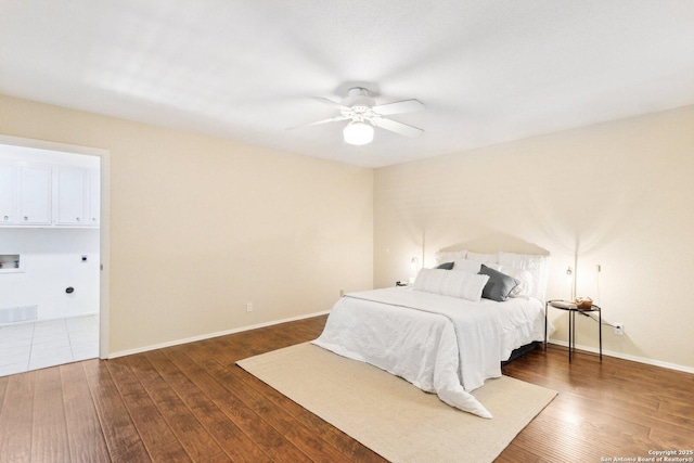 bedroom with ceiling fan and dark hardwood / wood-style floors