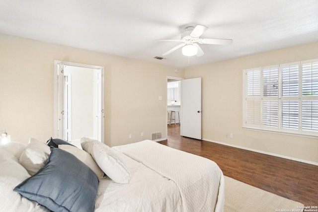 bedroom with ceiling fan and dark wood-type flooring