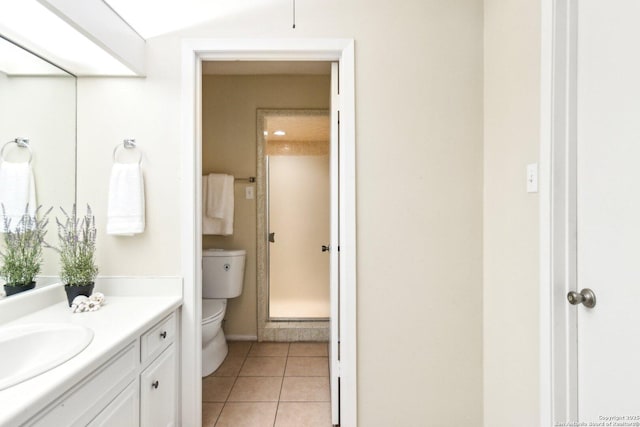 bathroom featuring vanity, tile patterned floors, and toilet