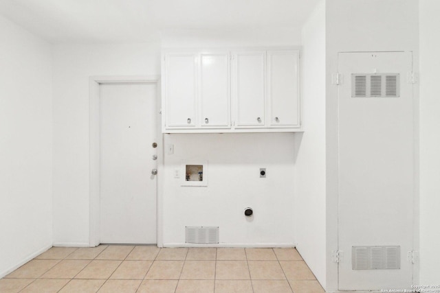 laundry area with light tile patterned flooring, electric dryer hookup, hookup for a washing machine, and cabinets