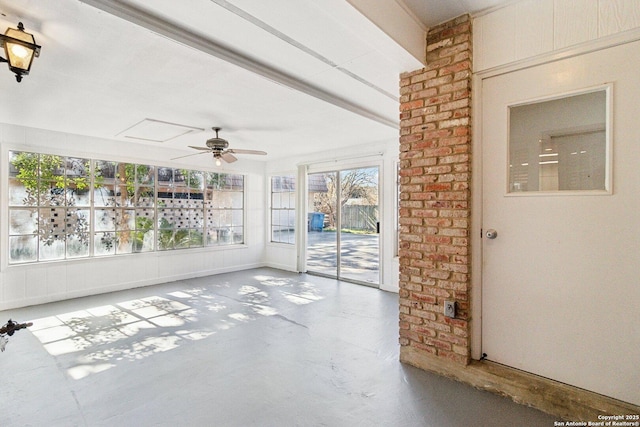 unfurnished sunroom with ceiling fan