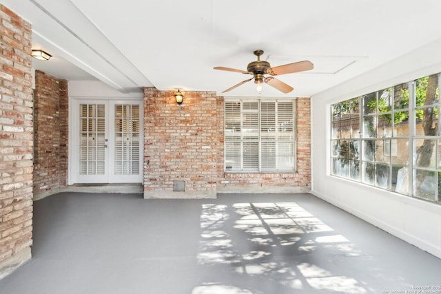 unfurnished sunroom featuring french doors and ceiling fan