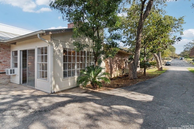 view of side of property with cooling unit