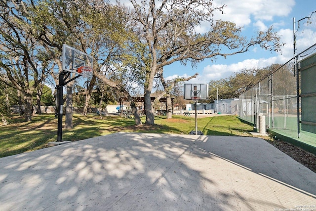 view of basketball court with a yard