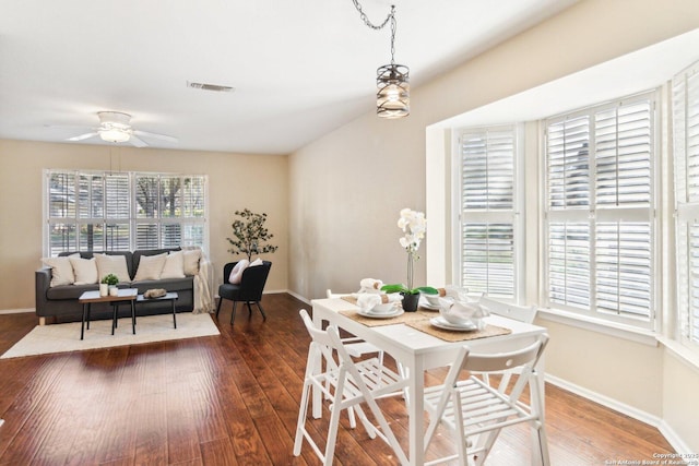 dining space with ceiling fan and dark hardwood / wood-style floors