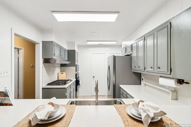 kitchen with stainless steel appliances, gray cabinets, and sink